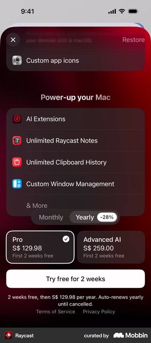 Raycast paywall headed Power-up your Mac listing AI Extensions, Unlimited Raycast Notes, Unlimited Clipboard History and Custom Window Management. A Monthly and Yearly toggle has Yearly selected with a minus 28% tag. Two plan cards read Pro at S dollar 129.98 and Advanced AI at S dollar 259.00, both with First 2 weeks free. A white button reads Try free for 2 weeks above the line 2 weeks free then S dollar 129.98 per year, auto-renews yearly until cancelled